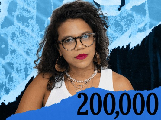A woman wearing glasses stands against a blue and black textured background featuring the numbers 200,000 prominently displayed.