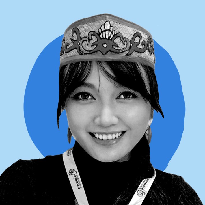 B&W Picture of Emmanuela Shinta against a light and dark blue graphic background.